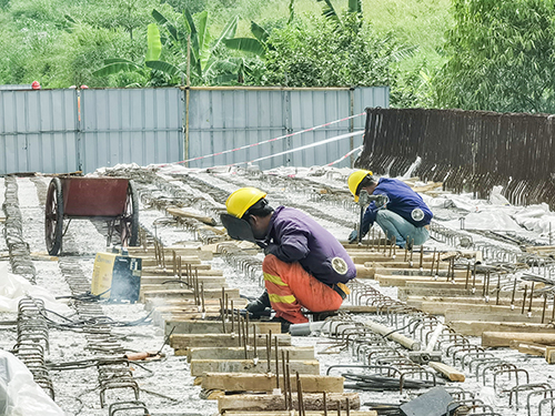 驮麻桥项目施工现场，工人们在烈日下坚守岗位。